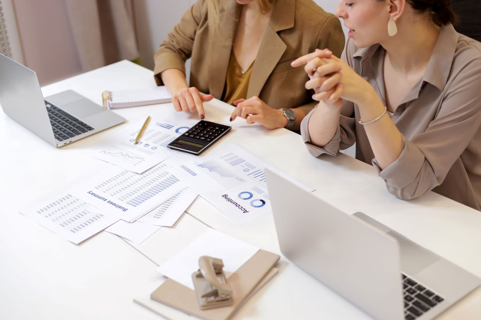 Accountant and small business owner reviewing financial strategy documents together