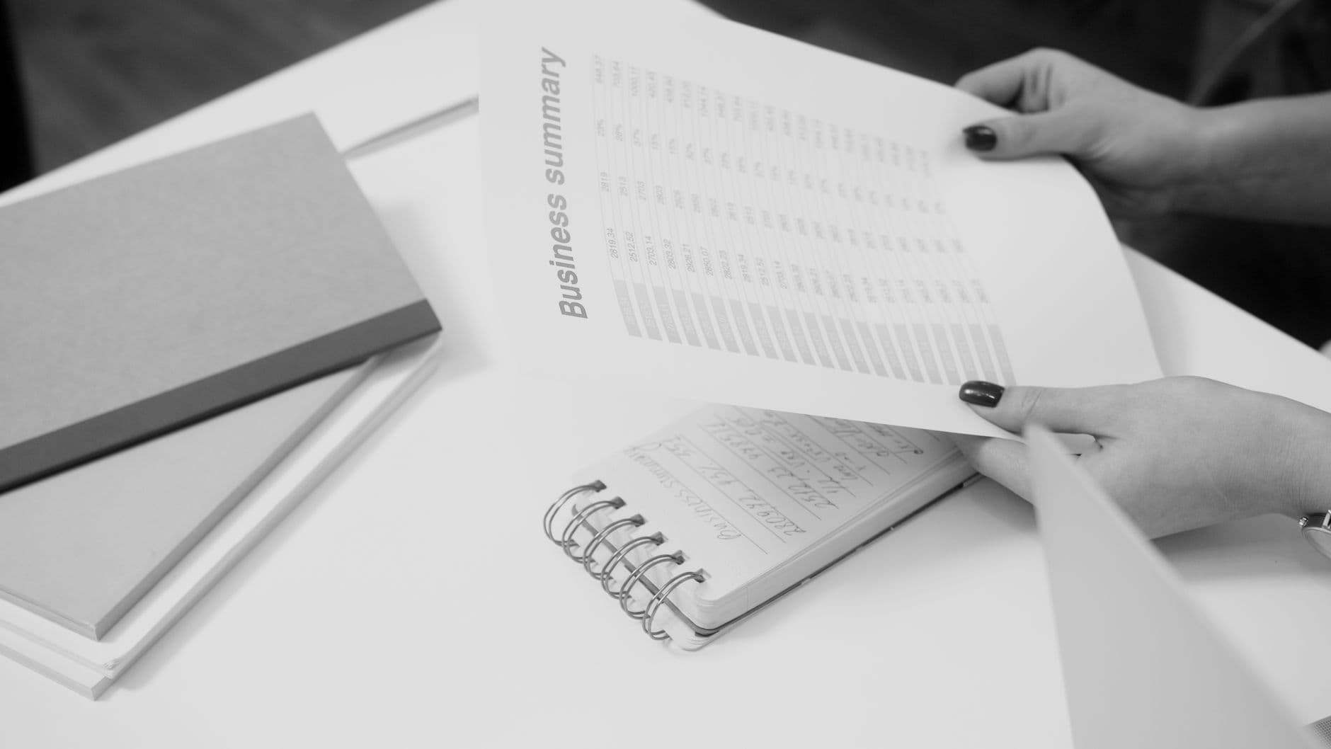 Accountant reconciling bank statements and financial reports on a laptop
