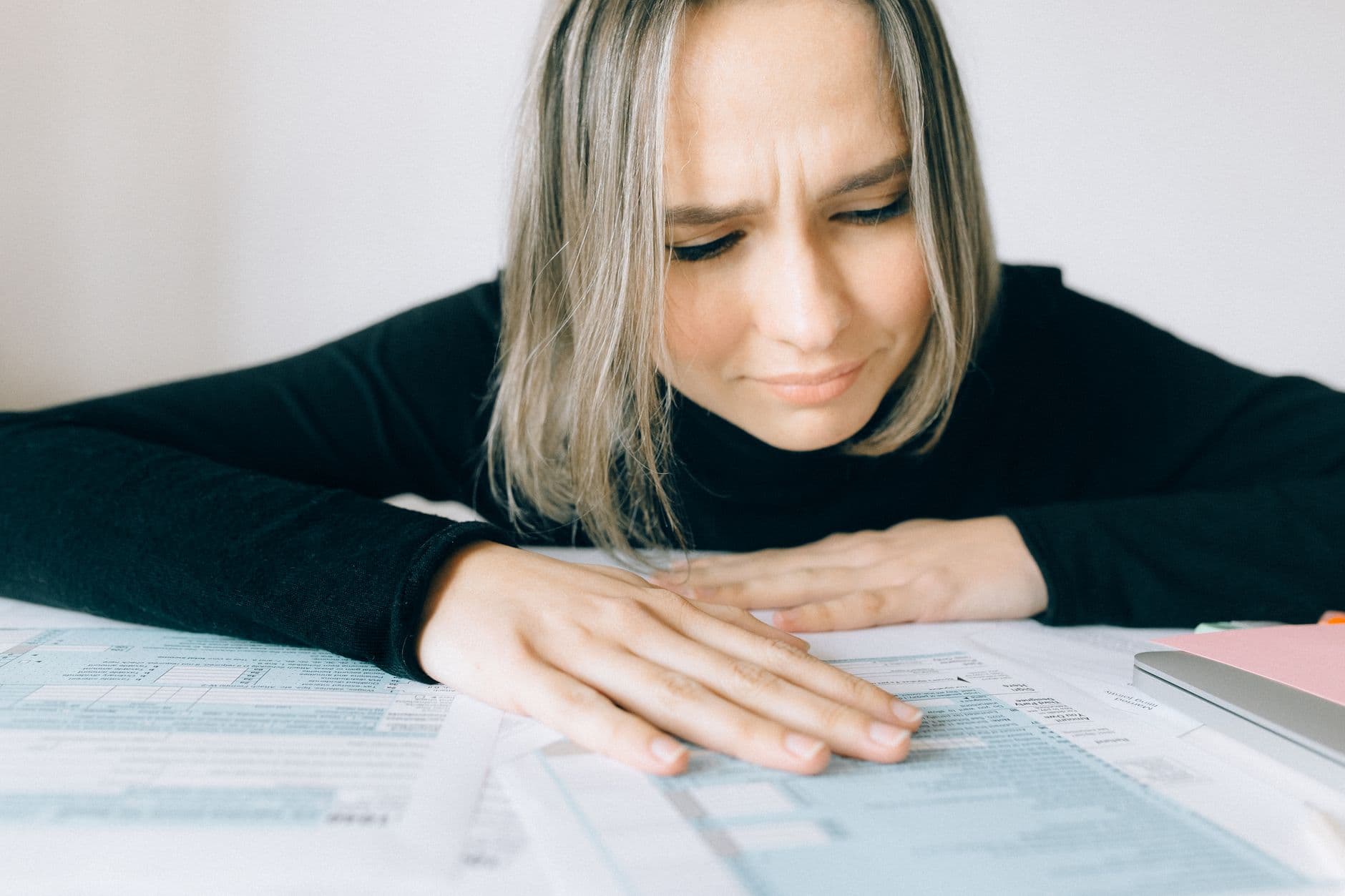 Accountant reviewing tax documents with a small business client at a desk