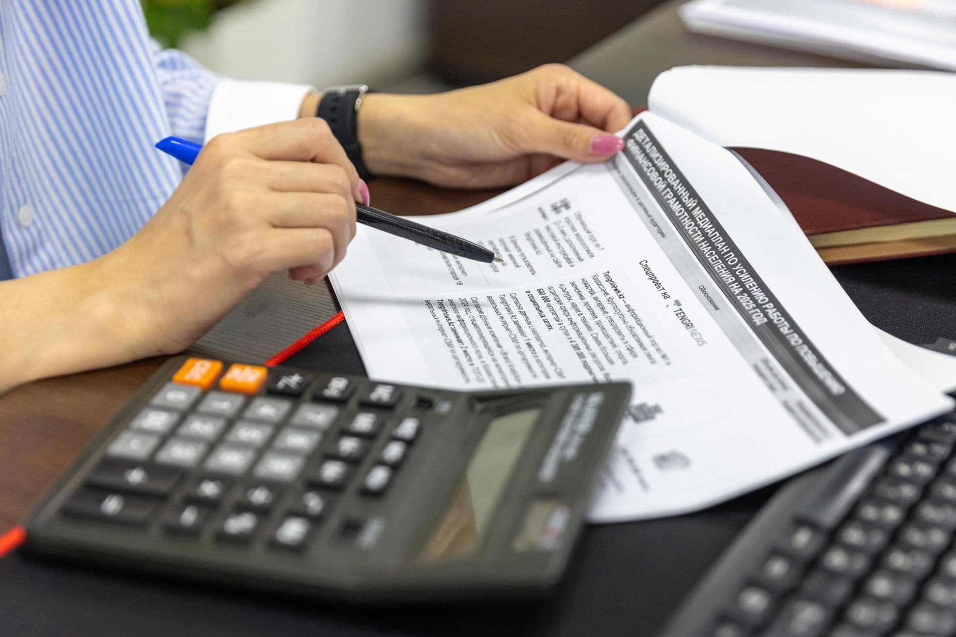 Accountant and small business owner reviewing financial reports together at a desk