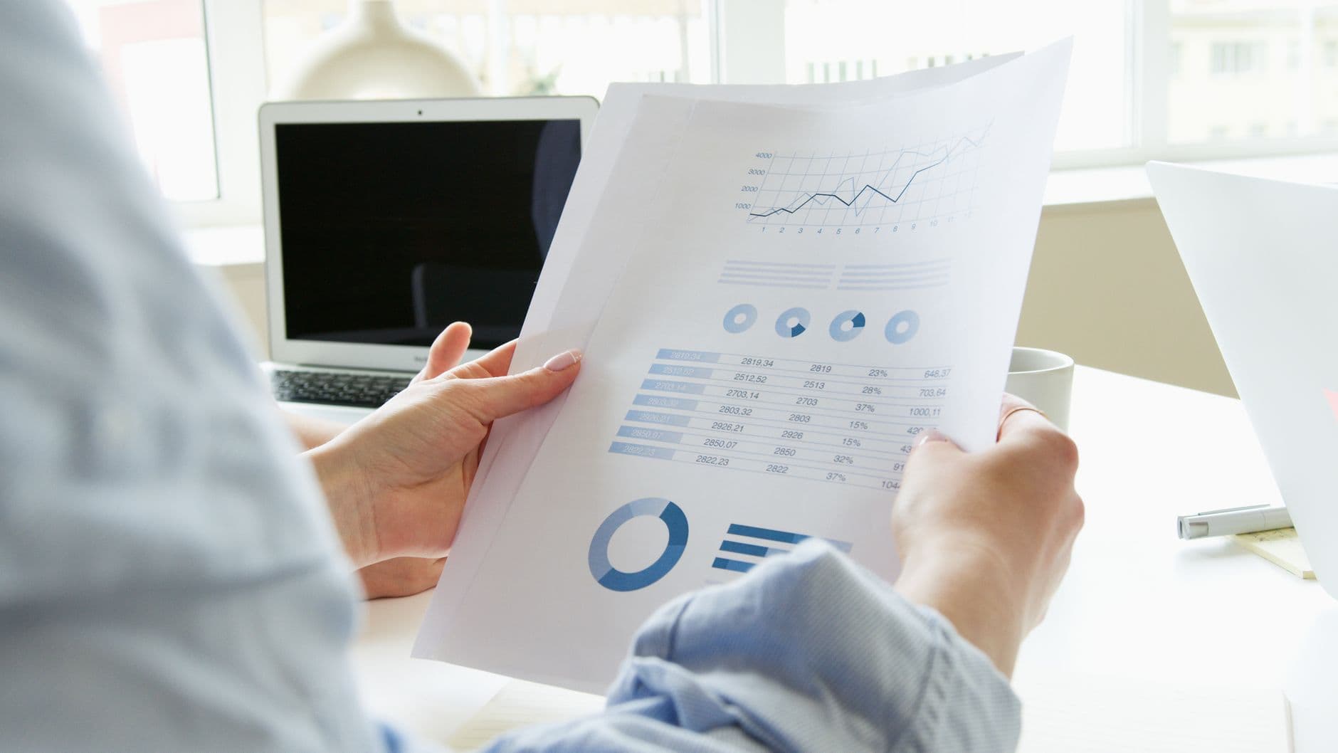 Accountant reviewing multi-channel sales and financial reports on a laptop