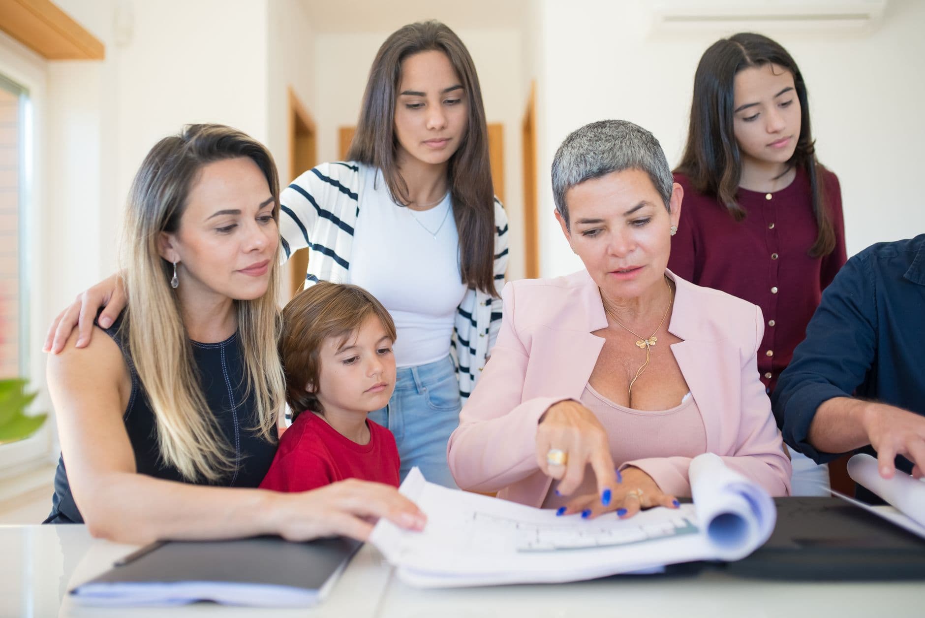 Advisor reviewing financial documents with a multi-generational family at a table