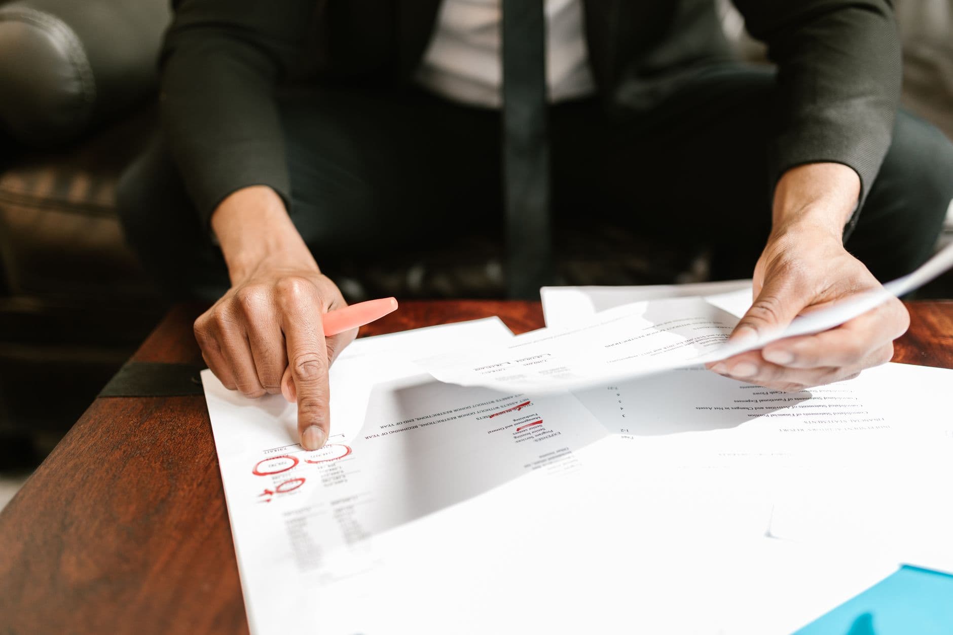Property manager reviewing financial statements at a desk with a laptop